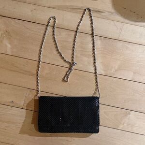 Jessica McClintock’s Black Sequin Clutch, adorned with a silver vintage .